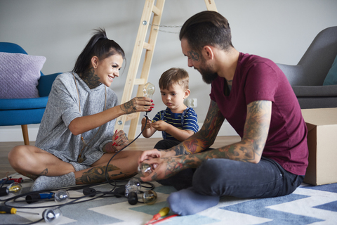 Happy modern family decorating the home for Christmas stock photo