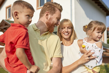 Portrait of happy family in garden of their home - ZEDF01546