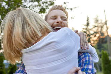 Happy couple hugging outdoors - ZEDF01562