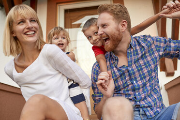 Happy family on porch of their home - ZEDF01570