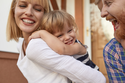 Close-up of happy family in front of their home stock photo