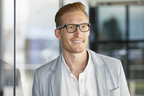 Portrait of smiling redheaded businessman wearing glasses - RBF06727