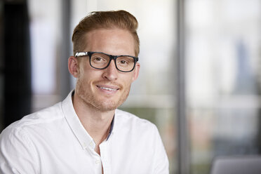 Portrait of smiling redheaded businessman wearing glasses - RBF06762