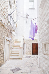 Italy, Puglia, Polognano a Mare, narrow alley and staircase at historic old town - FLMF00040