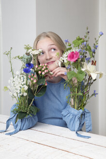 Blondes Mädchen mit Blumensträußen in den Ärmeln ihres Kleides - PSTF00214