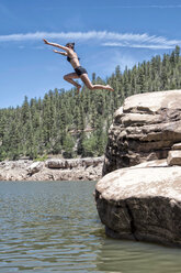 Two young women cliff jumping in the Blue Ridge Reservoir, Coconino National Forest, Arizona - AURF05715