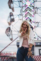 Portrait of smiling young woman on a funfair - KKAF02013