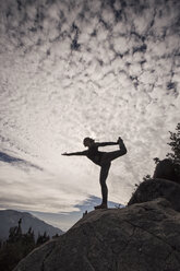 A woman practices yoga on a cliff in Sequoia National Park, California. - AURF05852