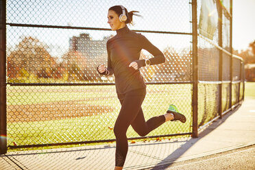 A Woman With Her Headphones Running On Ground In Boston, Usa - AURF05867