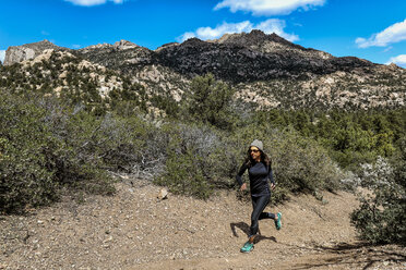 Athletic ultra marathon woman running in mountains - AURF05960