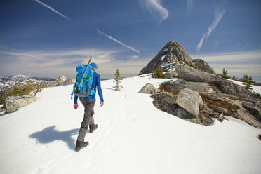 Backpacker approaching Needle Peak in winter, Hope, British Columbia, Canada - AURF05966