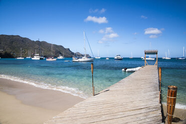 Boats and wooden pier by ocean - AURF05996