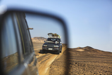 Car reflecting in car mirror during driving on desert - AURF06039