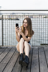 Junge Frau macht Selfies am East River - GIOF04510