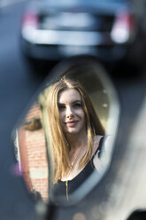 Portrait of a woman reflecting in a rear mirror - GIOF04530