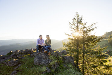 Couple sitting together in natural scenery in mountains at Horse Rock Ridge, Marcola, Oregon, USA - AURF06174