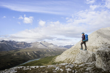 Female hiker at viewpoint on Stone Mountain British Columbia in Northern Rockies - AURF06247