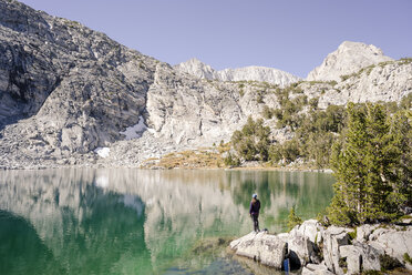 Female hiker standing by lake - AURF06248