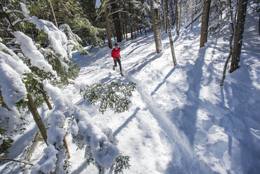 Elevated view of man running on trail covered in snow - AURF06249