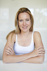 Portrait of a beautiful blond woman, with arms crossed - PNEF00965