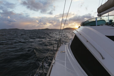 Sailboat sailing in sea against cloudy sky during sunset - CAVF48844