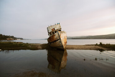 Abandoned boat at beach against sky during sunset - CAVF48848