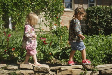 Side view of friends walking on stones at park - CAVF48931