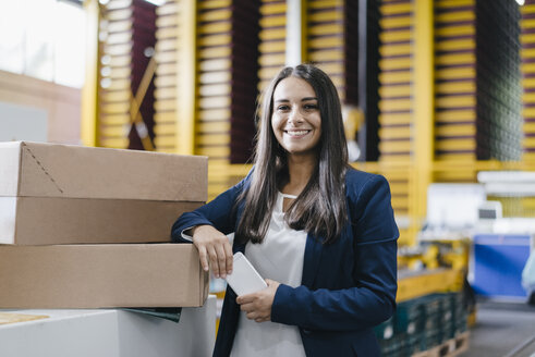 Young woman working in distribution warehouse - KNSF04893