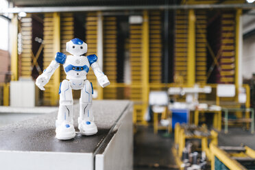Toy robot standing on shelf in logistics center - KNSF04918