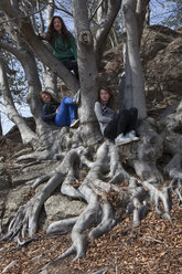 Teenager-Mädchen entspannen sich in Baumstämmen, Hartholz-Wald - AURF06486