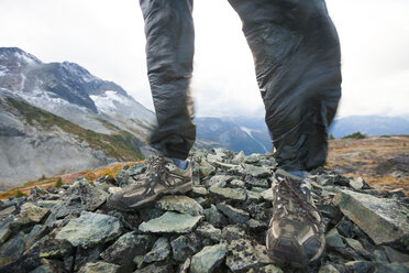 Low section of man standing on stones - AURF06570