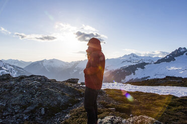 Man in winter jacket standing in snowy mountains at Sahale Arm of Sahale Peak, North Cascades National Park, Washington State, USA - AURF06619