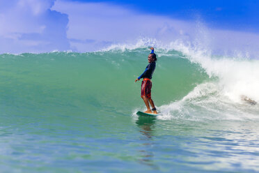 Male surfer riding wave, Kuta, Lombok, Indonesia - AURF06621