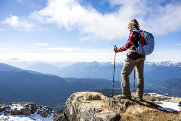 Female hiker looking at view of Garibaldi Provincial Park from top of Whistler Mountain, Whistler, British Columbia, Canada - AURF06822