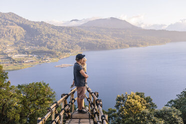 Father and son looking at view of Lake Buyan, Bedugul, Bali, Indonesia - AURF06872