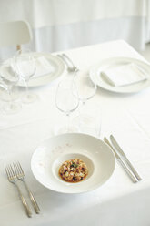 Food on plate against white table, La Rioja, Pamplona, Spain - AURF07045