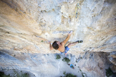 Man climbing rock wall, Pobla de Segur, Lleida, Spain - AURF07072