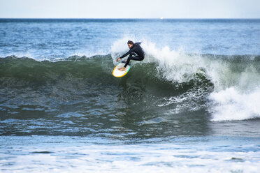 Man surfing hurricane surf, Point Judith, Narragansett, Rhode Island, USA - AURF07073