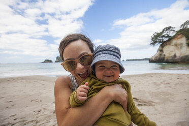 Mother and son playing on beach, Hahei, Coromandel, New Zealand - AURF07183