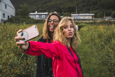 Traveling friends taking smartphone selfies in Northern Norway - KKAF02037