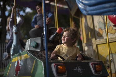 Toddler in carousel ride, Esquel, Chubut Province, Argentina - AURF07301