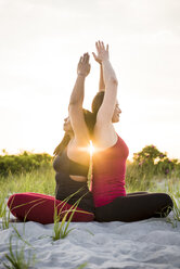 Two women doing yoga, Newport, Rhode Island, USA - AURF07373