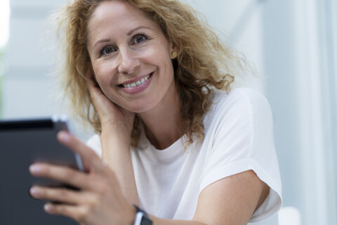 Porträt einer lächelnden Frau mit Tablet, lizenzfreies Stockfoto