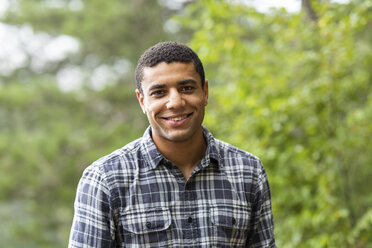 Portrait of smiling young man outdoors - WPEF00892