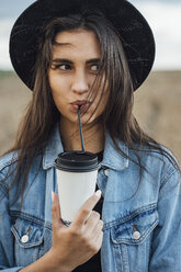 Portrait of young woman drinking beverage - VPIF00894