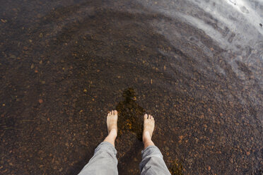 Feet of a man in water of a lake - KKAF02138