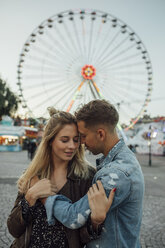 Young couple in love, embracing at a funfair - LHPF00105