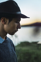 Portrait of a young man with hat at a lake - KKAF02224