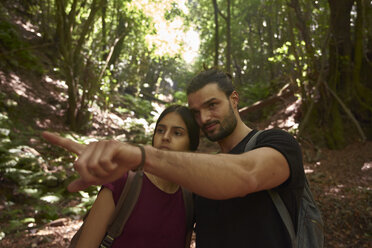 Spain, Canary Islands, La Palma, couple in a forest with man pointing his finger - PACF00153