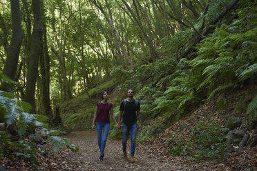 Spanien, Kanarische Inseln, La Palma, Paar geht Hand in Hand durch einen Wald - PACF00163